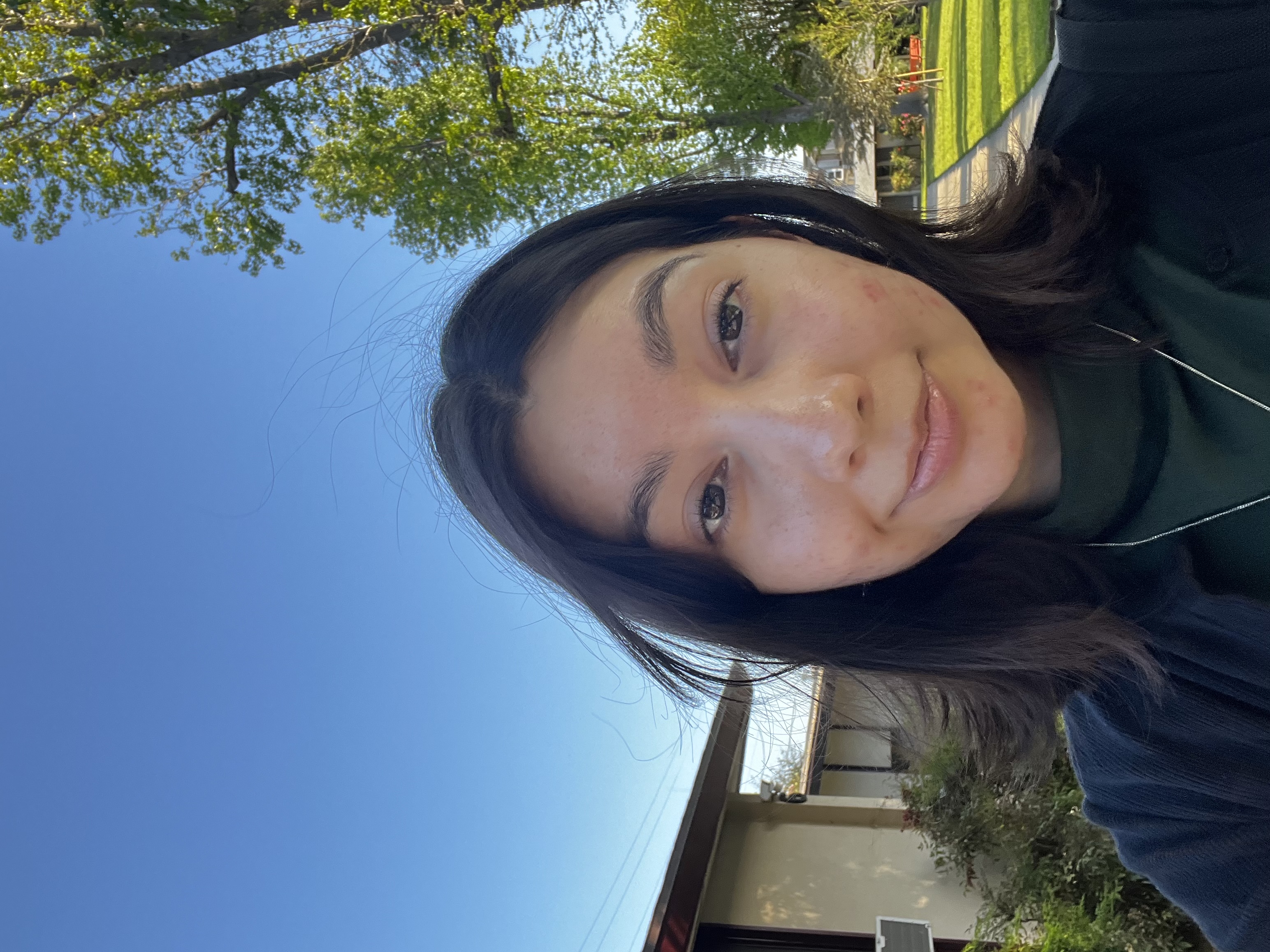 A picture of me in a green shirt with a nature bon background