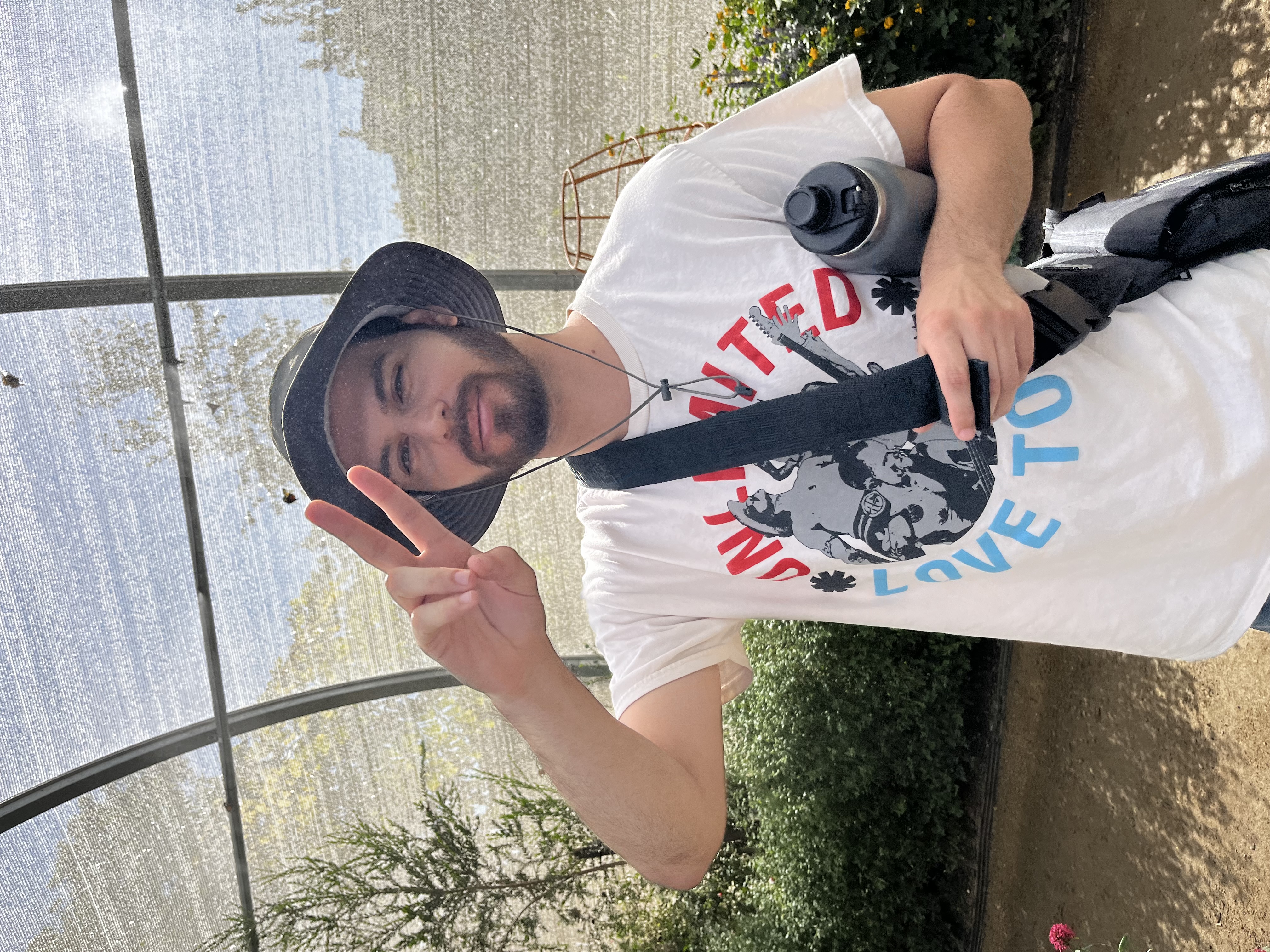 Nathan holding a piece sign